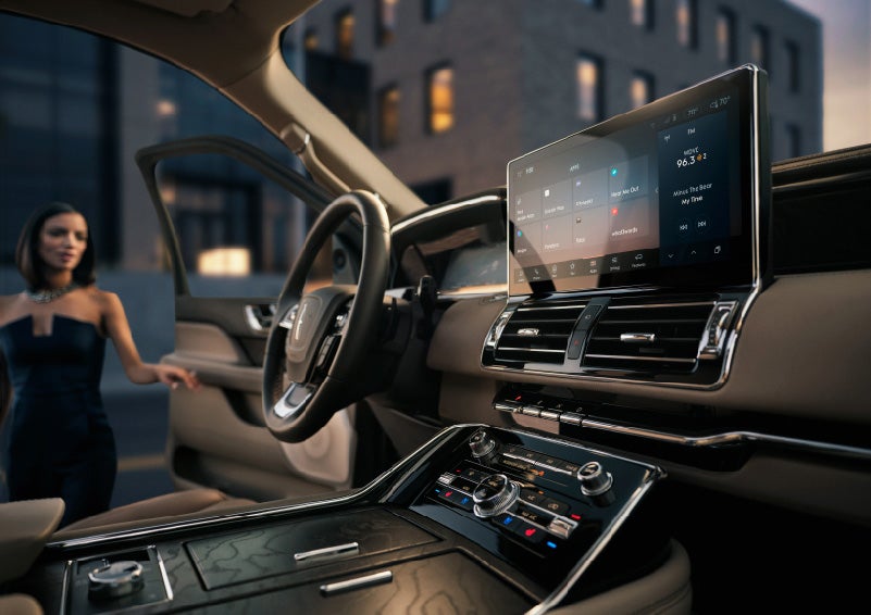 The 13.2-inch LCD touchscreen dominates the front cabin as a woman gets in the driver's door | Klaben Lincoln in Kent OH