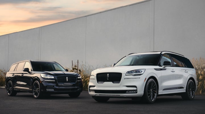 Two Lincoln Aviator® SUVs are shown with the available Jet Appearance Package | Klaben Lincoln in Kent OH