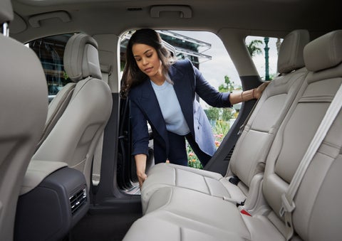 A woman slides the second-row seat forward to create more cargo space | Klaben Lincoln in Kent OH