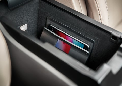 A smartphone device is securely tucked into the available wireless charging pad for an effortless energy boost | Klaben Lincoln in Kent OH