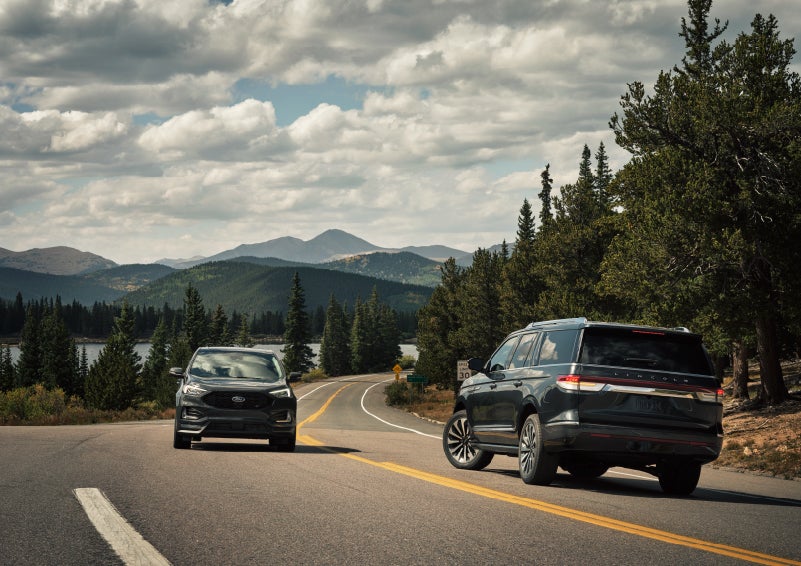 A 2022 Lincoln Navigator SUV is making a left turn as another vehicle approaches from the other lane | Klaben Lincoln in Kent OH