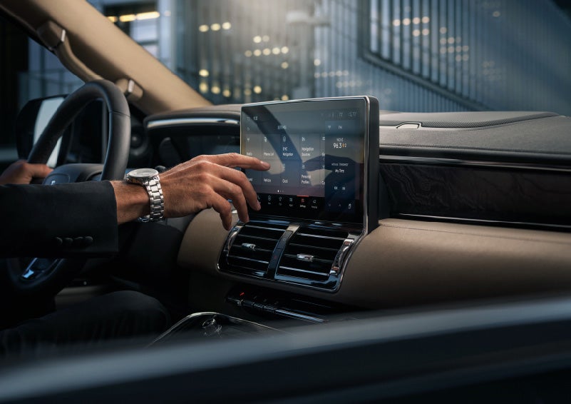 A hand is about to press the personal profiles tile on the settings screen | Klaben Lincoln in Kent OH