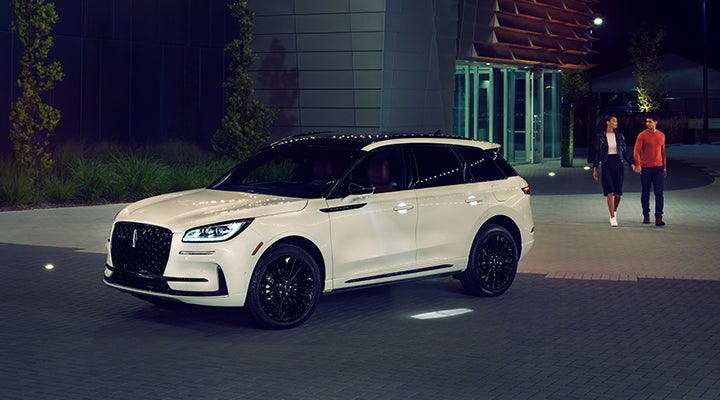 Two people approach a 2024 Lincoln Corsair® SUV featuring the available Jet Appearance Package. | Klaben Lincoln in Kent OH