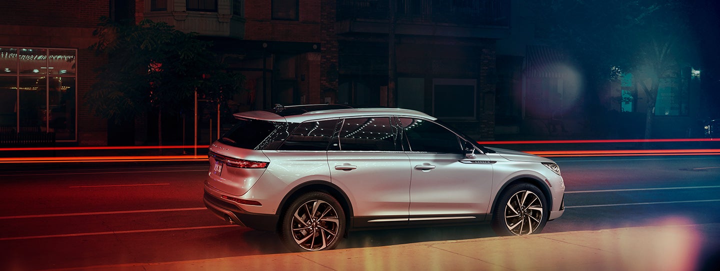 The 2024 Lincoln Corsair® SUV is parked on a city street at night. | Klaben Lincoln in Kent OH
