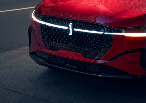 The available front LED light bar and center Lincoln Star logo glow at dusk. | Klaben Lincoln in Kent OH