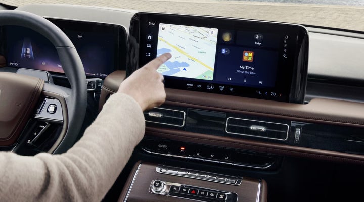 A person is tapping the center display touchscreen of a 2026 Lincoln Aviator® SUV. | Klaben Lincoln in Kent OH