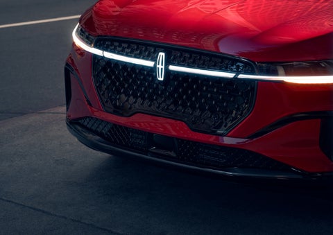 The available front LED light bar and center Lincoln Star logo glow at dusk. | Klaben Lincoln in Kent OH