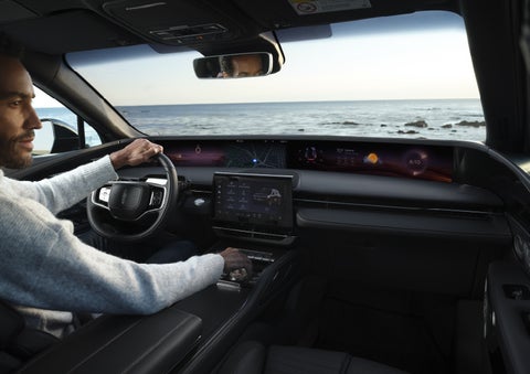 A driver of a parked 2026 Lincoln Nautilus® SUV takes a relaxing moment at a seaside overlook while inside his Nautilus. | Klaben Lincoln in Kent OH