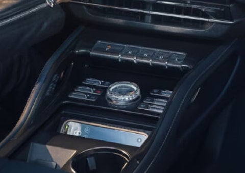 A smartphone is shown charging in the wireless charging pad. | Klaben Lincoln in Kent OH