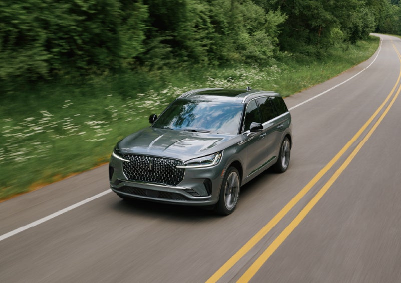 A 2027 Lincoln Aviator® SUV is being driven down a road. | Klaben Lincoln in Kent OH