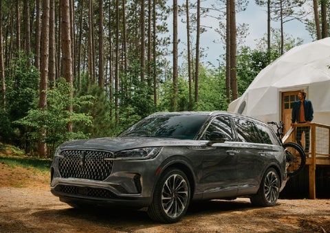 A 2027 Lincoln Aviator® is parked next to a high end glamping site. | Klaben Lincoln in Kent OH