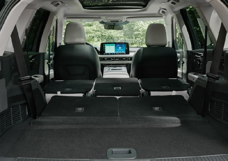 A rear to front view of the interior of a 2027 Lincoln Aviator® Black Label™ SUV shows the third and second rows folded flat | Klaben Lincoln in Kent OH