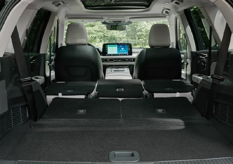 A rear to front view of the interior of a 2027 Lincoln Aviator® Black Label™ SUV shows the third and second rows folded flat | Klaben Lincoln in Kent OH